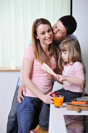 happy young family have lunch time with fresh fruits and vegetable food in bright kitchen Stock Photo - Budget Royalty-Free & Subscription, Code: 400-05211861