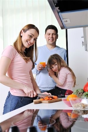 happy young family have lunch time with fresh fruits and vegetable food in bright kitchen Stock Photo - Budget Royalty-Free & Subscription, Code: 400-05211863