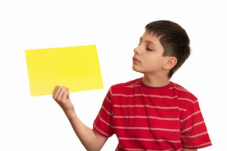 A kid in red shirt is holding a yellow sheet of paper in his hand, isolated on the white background Stock Photo - Budget Royalty-Free & Subscription, Code: 400-05211915