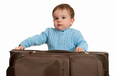 A toddler is packing a suitcase; isolated on the white background Stock Photo - Budget Royalty-Free & Subscription, Code: 400-05211920