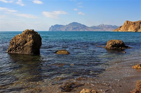 simsearch:400-05678506,k - Seascape - stone, sand, clear water, and in the distance an old volcano Stockbilder - Microstock & Abonnement, Bildnummer: 400-05212679