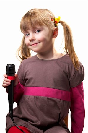 Funny little girl singing with microphone isolated over white background Stockbilder - Microstock & Abonnement, Bildnummer: 400-05212868