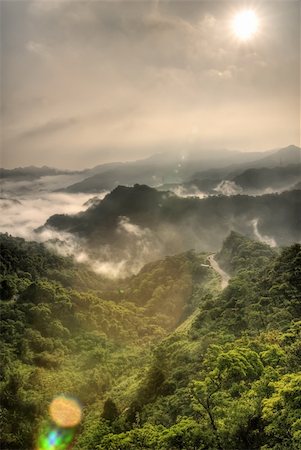 Mountain scenery with sun light and flare over dramatic clouds in sky. Stock Photo - Budget Royalty-Free & Subscription, Code: 400-05213255