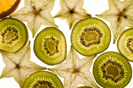 sliced carambola - Fruit background: slices carambola, orange and kiwi Photographie de stock - Aubaine LD & Abonnement, Code: 400-05213428