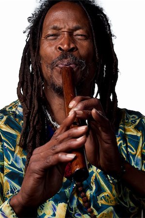 rastafarian - Man plays a traditional wooden flute, studio image Stock Photo - Budget Royalty-Free & Subscription, Code: 400-05213768