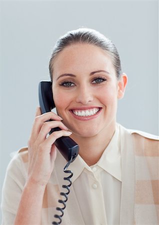 simsearch:400-04341796,k - Portrait of a smiling businesswoman talking on phone in the office Stockbilder - Microstock & Abonnement, Bildnummer: 400-05224331