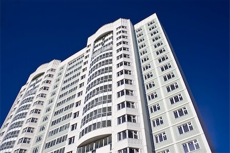 sailorr (artist) - High modern apartment building under blue sky Foto de stock - Super Valor sin royalties y Suscripción, Código: 400-05224801