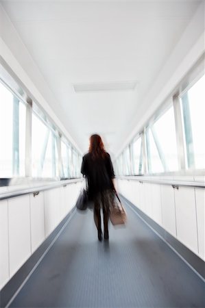 Motion Blured woman  in the corridor of an airport. Stock Photo - Budget Royalty-Free & Subscription, Code: 400-05225189