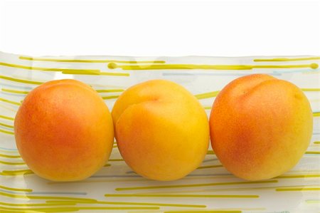 simsearch:649-06432885,k - Three fresh apricots arranged on decorative glass plate. Stockbilder - Microstock & Abonnement, Bildnummer: 400-05225880