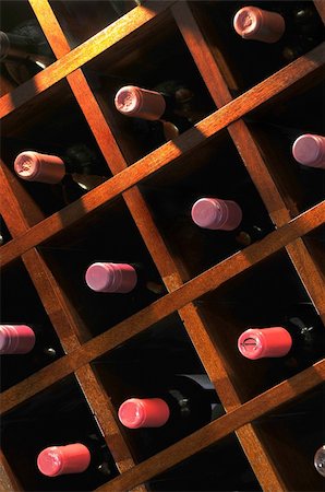 A wall mounted wine rack in cellar, with necks of assorted bottlles of red wine showing Stock Photo - Budget Royalty-Free & Subscription, Code: 400-05227035