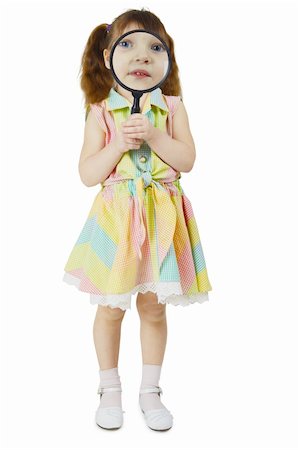 The little girl looks at you through a large magnifying glass on white Stock Photo - Budget Royalty-Free & Subscription, Code: 400-05227662