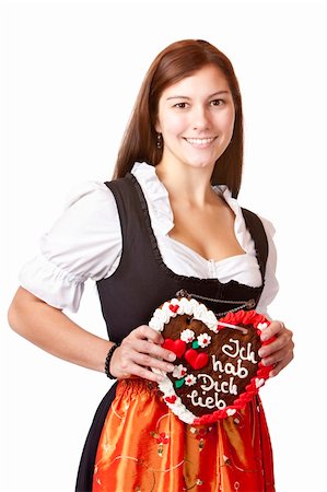 simsearch:400-07087495,k - woman in love wearing Dirndl cloth holds gingerbread heart. Isolated on white background. Stock Photo - Budget Royalty-Free & Subscription, Code: 400-05227881
