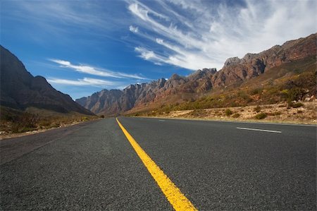Road through the mountains in South Africa in the Western Cape with great High clouds Stock Photo - Budget Royalty-Free & Subscription, Code: 400-05228039