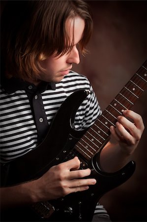 simsearch:400-04165960,k - Young Musician Plays His Electric Guitar with Dramatic Lighting. Stock Photo - Budget Royalty-Free & Subscription, Code: 400-05228438