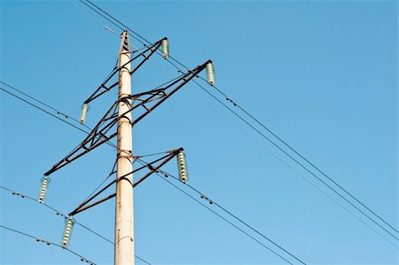 high voltage power supply line on a blue sky background Stock Photo - Budget Royalty-Free & Subscription, Code: 400-05228656