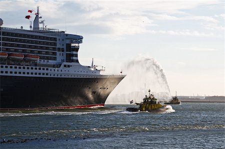 port rotterdam - Fire fighting boat spraying jets of water when cruiseship passes by on the river Stock Photo - Budget Royalty-Free & Subscription, Code: 400-05229082