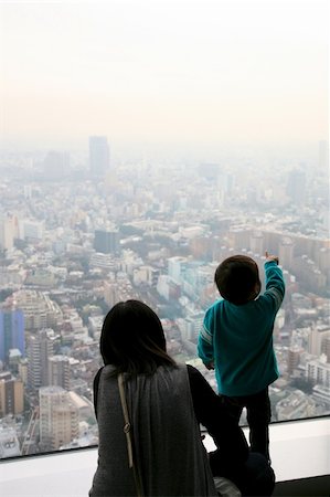 A little japanese boy is showing something to his mother in the immensity of the city of tokyo. The scene is taking place in the roppongi hill skyscraper . Stock Photo - Budget Royalty-Free & Subscription, Code: 400-05229475