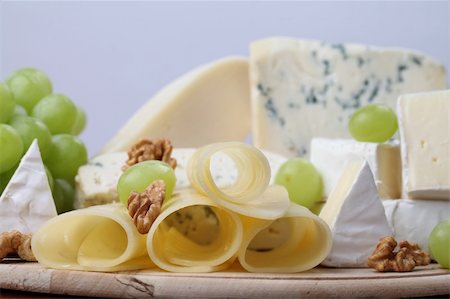 emmentaler cheese - Various kinds of cheese with walnuts and grapes Stock Photo - Budget Royalty-Free & Subscription, Code: 400-05229589