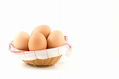 raphtong (artist) - eggs in a wicker basket on white background Fotografie stock - Microstock e Abbonamento, Codice: 400-05220361