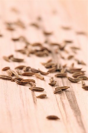 simsearch:400-04754857,k - Closeup of cummin seeds on a wooden table. Shallow dof, selective focus Stock Photo - Budget Royalty-Free & Subscription, Code: 400-05220752