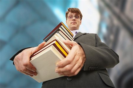 A librarian holding a big pile of books Stock Photo - Budget Royalty-Free & Subscription, Code: 400-05221573