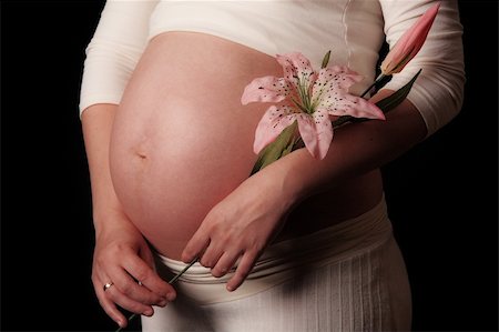 simsearch:400-07892376,k - Pregnant mother holding belly exposing the bump Foto de stock - Royalty-Free Super Valor e Assinatura, Número: 400-05221926