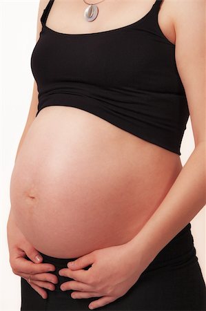 simsearch:400-07892376,k - Pregnant mother holding belly exposing the bump Foto de stock - Royalty-Free Super Valor e Assinatura, Número: 400-05221922