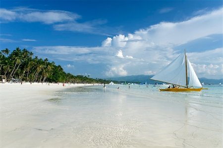 traditional paraw sailing boats on white beach on boracay island in the philippines Stock Photo - Budget Royalty-Free & Subscription, Code: 400-05222506