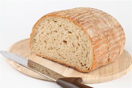 Loaf of fresh bread on cutting board Stock Photo - Budget Royalty-Free & Subscription, Code: 400-05222956