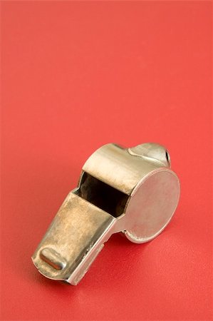 people whistling - old metal whistle on red background, vertical photo Stock Photo - Budget Royalty-Free & Subscription, Code: 400-05223768