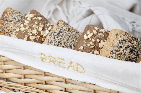 simsearch:400-04699541,k - Basket with different kinds of wholemeal bread. Focus on the embroidered word "bread" on the basket. Foto de stock - Super Valor sin royalties y Suscripción, Código: 400-05234005