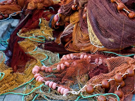 Fishing nets laid on the dock waiting to be repaired Stock Photo - Budget Royalty-Free & Subscription, Code: 400-05234139
