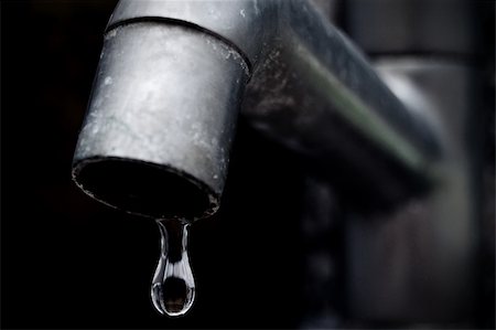 An old leaky faucet with focus on a drop of water, meaning the waste of water in the world. Stock Photo - Budget Royalty-Free & Subscription, Code: 400-05234156