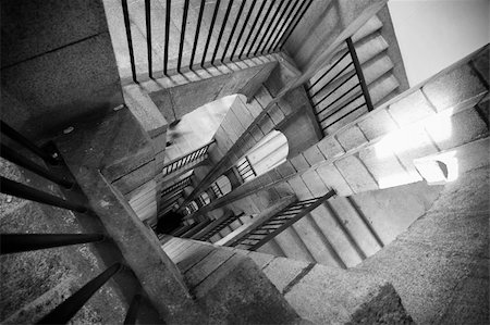 spiral staircase people - A black and white stair with shadows and light Stock Photo - Budget Royalty-Free & Subscription, Code: 400-05234233