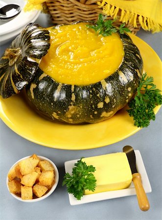 Delcious pumpkin soup in a pumkin with croutons and butter. Stock Photo - Budget Royalty-Free & Subscription, Code: 400-05234261