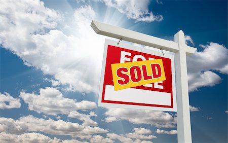 simsearch:400-03937070,k - Sold For Sale Real Estate Sign over Clouds and Blue Sky with Sun Rays. Stock Photo - Budget Royalty-Free & Subscription, Code: 400-05234409