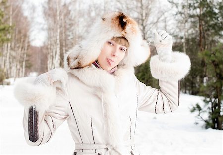 simsearch:400-06132090,k - winter portrait of young and beautiful natural looking woman in casual clothes showing her tongue Photographie de stock - Aubaine LD & Abonnement, Code: 400-05234813