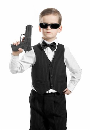 secret agent - Boy with a weapon on a white background Stock Photo - Budget Royalty-Free & Subscription, Code: 400-05235111