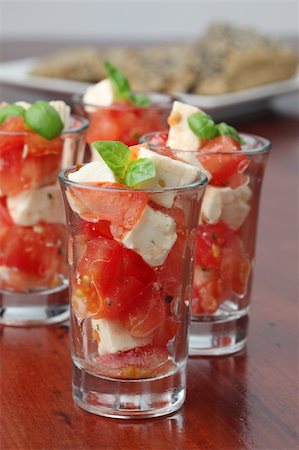 simsearch:400-07172265,k - Appetizers with tomatoes, mozzarella and basil in small glasses Foto de stock - Royalty-Free Super Valor e Assinatura, Número: 400-05235436