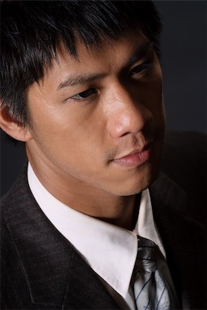 Closeup portrait of young business man, handsome Asian guy with lonely face. Stock Photo - Budget Royalty-Free & Subscription, Code: 400-05238207