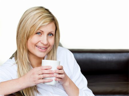 Self-assured woman holding a cup of coffee against a white background Stock Photo - Budget Royalty-Free & Subscription, Code: 400-05238258