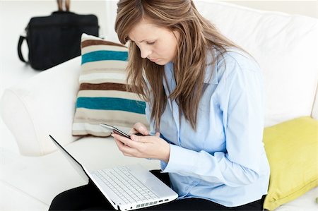 Radiant woman sitting on a sofa reading a book at home Stock Photo - Budget Royalty-Free & Subscription, Code: 400-05238259