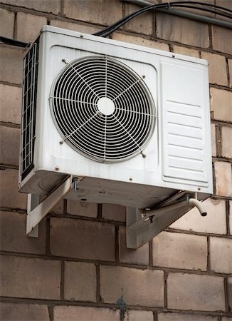 Air conditioning heat pump mounted on brick wall. Stock Photo - Budget Royalty-Free & Subscription, Code: 400-05238817
