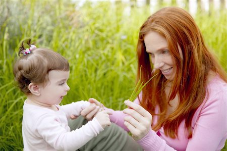 simsearch:400-05248187,k - baby and redhead mother outdoor grass playing park together Photographie de stock - Aubaine LD & Abonnement, Code: 400-05239966