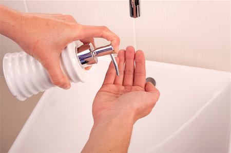 Squirting liquid soap into the palm of a hand Stock Photo - Budget Royalty-Free & Subscription, Code: 400-05230164