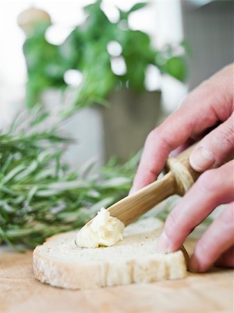 spreading butter on bread - Human spreading butter on bread Stock Photo - Budget Royalty-Free & Subscription, Code: 400-05230644