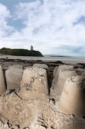 childrens sandcastles on a beach in ireland with cliffs and real castle in background Stock Photo - Budget Royalty-Free & Subscription, Code: 400-05230677