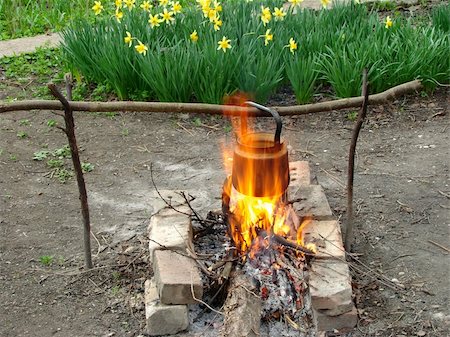 steaming kettles - boiling water in old sooty kettle on the hiking campfire Stock Photo - Budget Royalty-Free & Subscription, Code: 400-05230791