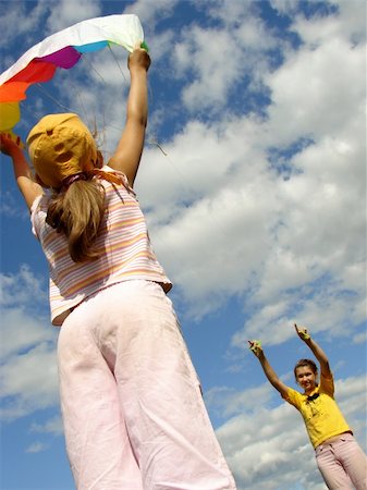 two sisters start flying kite against blue sky with clouds Stock Photo - Budget Royalty-Free & Subscription, Code: 400-05230792