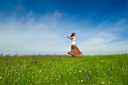 Young woman dancing on a beautiful green meadow Stock Photo - Budget Royalty-Free & Subscription, Code: 400-05230882